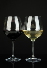 Two glasses of  red and white wine, isolated on black