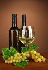 Obraz na płótnie Canvas Composition of wine bottles, glass of white wine, grape