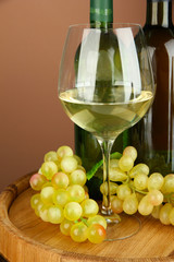 Composition of wine bottles, glass of white wine, grape