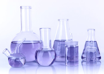 Test-tubes with light purple liquid isolated on white