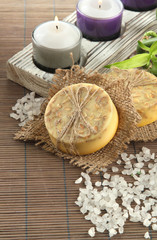 Hand-made soap and sea salt  on grey bamboo mat