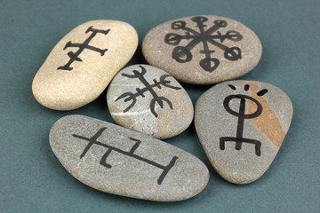 Fortune telling  with symbols on stones on grey background
