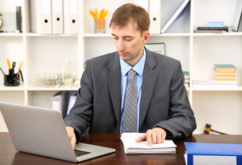 Young businessman in office at his workplace