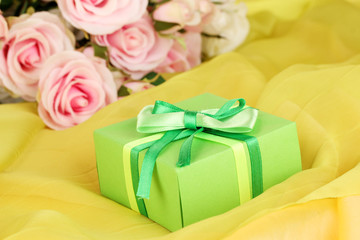 Beautiful gift on flowers background