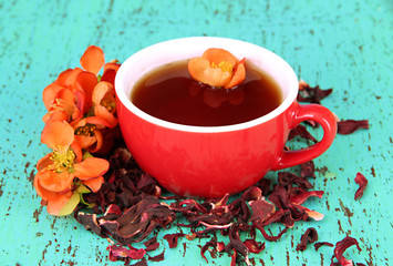Herbal tea in cup, on color wooden background