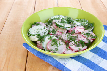 Vitamin vegetable salad in bowl on wooden table close-up