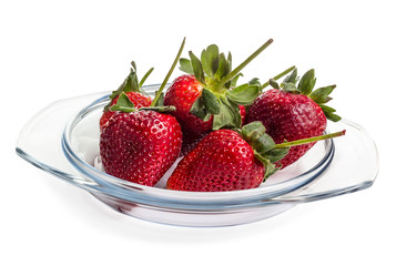 Strawberries lying on a transparent glass dish