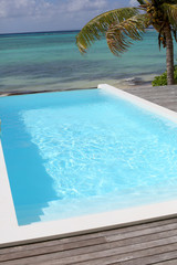 Fototapeta na wymiar View of swimming-pool with sea in background
