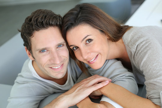 Upper view of sweet couple sitting in sofa