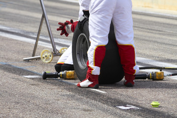 Mechanics prepared to change the tires of a car competition.