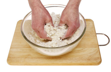 Hands mixing dough