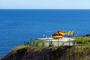 Helicopter EC-145 on a landing area with Mediterranean sea in background,Vermilion Coast, Roussillon, France