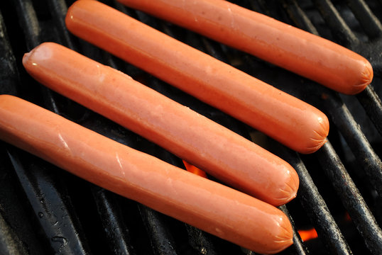 Raw Hotdogs On A Grill