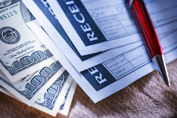 Blank receipt, money and red pen