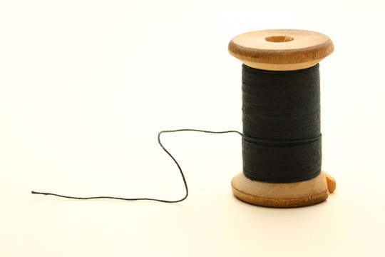 Black Thread With A Needle On An Ancient Antique Old Wooden Coil