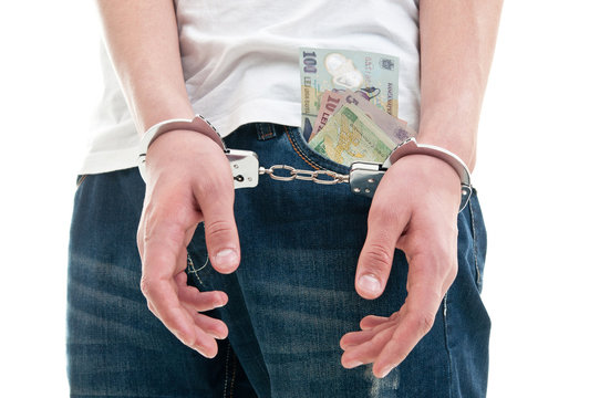Man with handcuffs and bills in his pocket