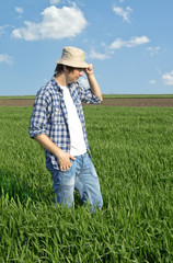 Naklejka na ściany i meble Farmer in a wheat field.