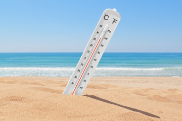 A thermometer on the beach near the sea to check the temperature