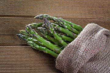 Fresh asparagus on a wooden background