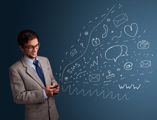 Boy typing on smartphone with various modern technology icons