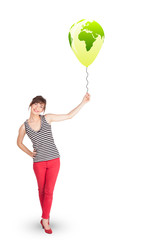 Happy lady holding a green globe balloon