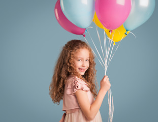 Smiling Girl Holding Balloons