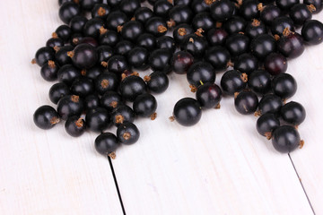 Black currant on wooden background