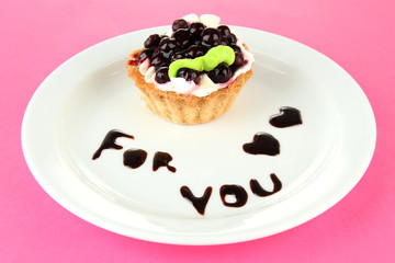 Sweet cake with blackberry and chocolate sauce