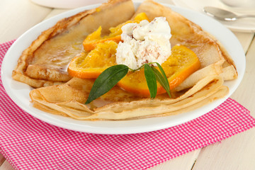 Pancakes with orange on napkin close-up