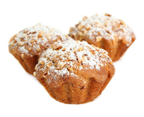 Tasty muffin cakes with powdered sugar, isolated on white
