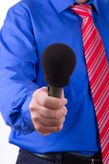 Businessman Reaching Microphone for Interview