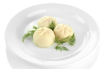 Tasty khinkali on plate, isolated on white