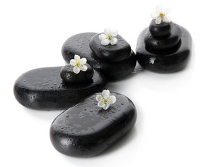 Spa stones and white flowers isolated on white