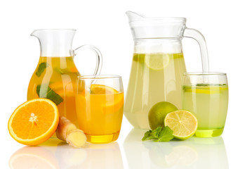 Orange and lemon lemonade in pitchers and glasses isolated