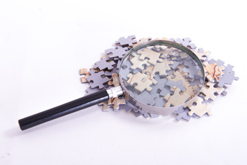 Magnifying Glass on Puzzle Pieces
