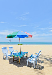 Sun shade with chairs at tropical beach