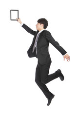 Young Businessman Holding Tablet PC Jumping