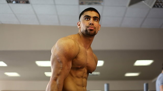 bodybuilder posing in the gym