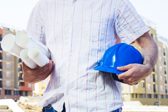 construction worker holding project and blue hard hat