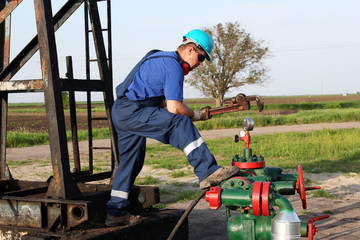 oil worker with wrench check pipeline