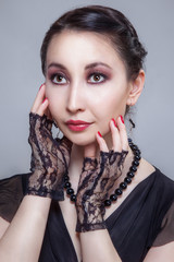 Asia girl with red nails and black beading