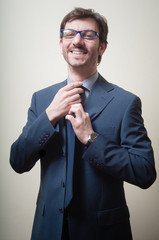success businessman adjusting tie