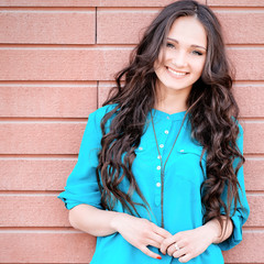 Young elegant woman in front of brick wall backround