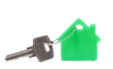 Key with house-shaped charm isolated on white