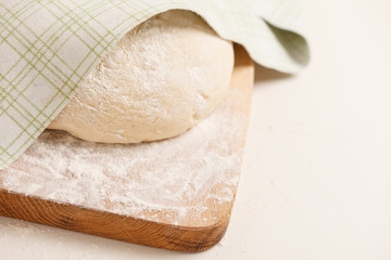 Dough on wooden board