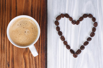 coffee and heart from coffee beans on a wooden surface