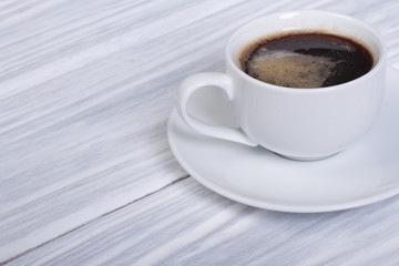 Black coffee on a white wooden table