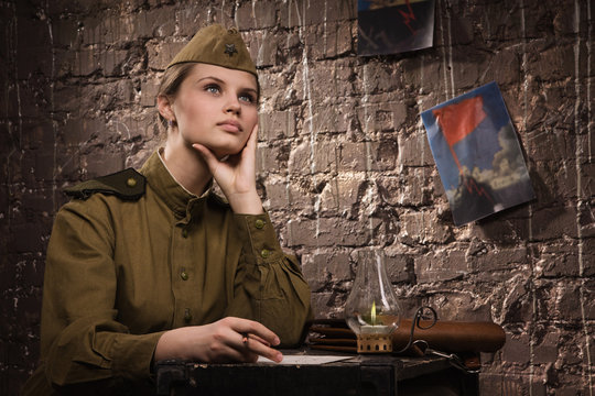 Soviet female soldier in uniform of World War II dreams