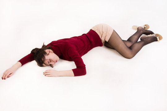 Lifeless brunette lying on the floor