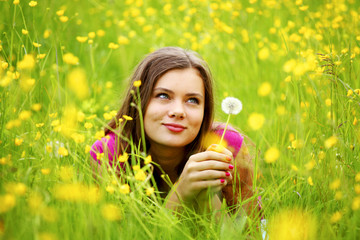 woman blow on dandelion